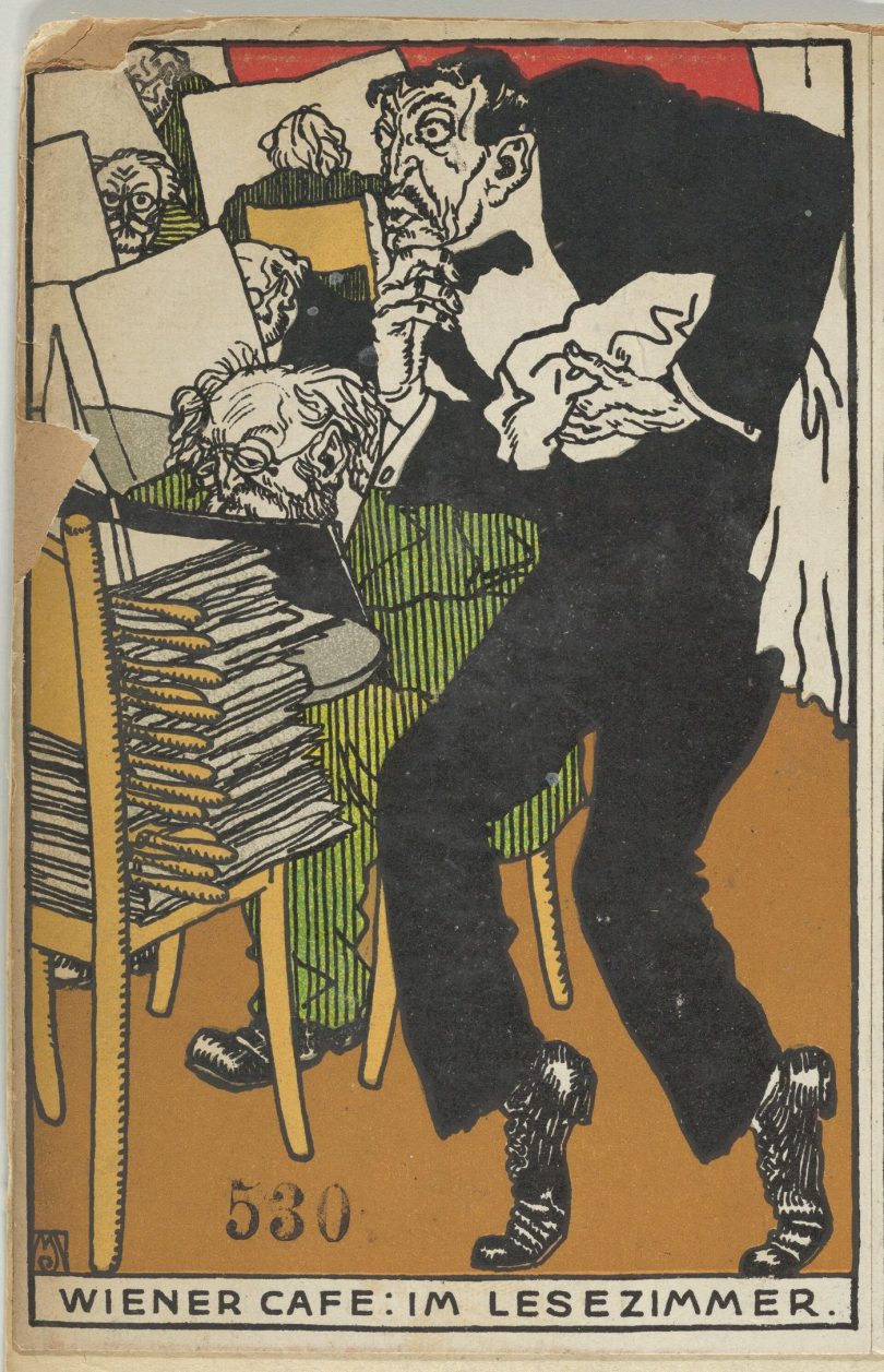 A person reading a newspaper in a cafe