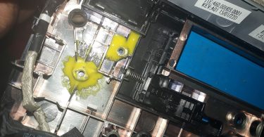 A laptop being repaired on a workbench