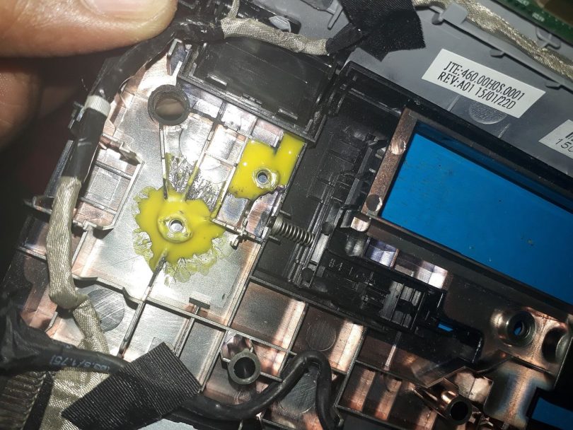 A laptop being repaired on a workbench