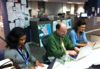 Newspapers moving through a printing press